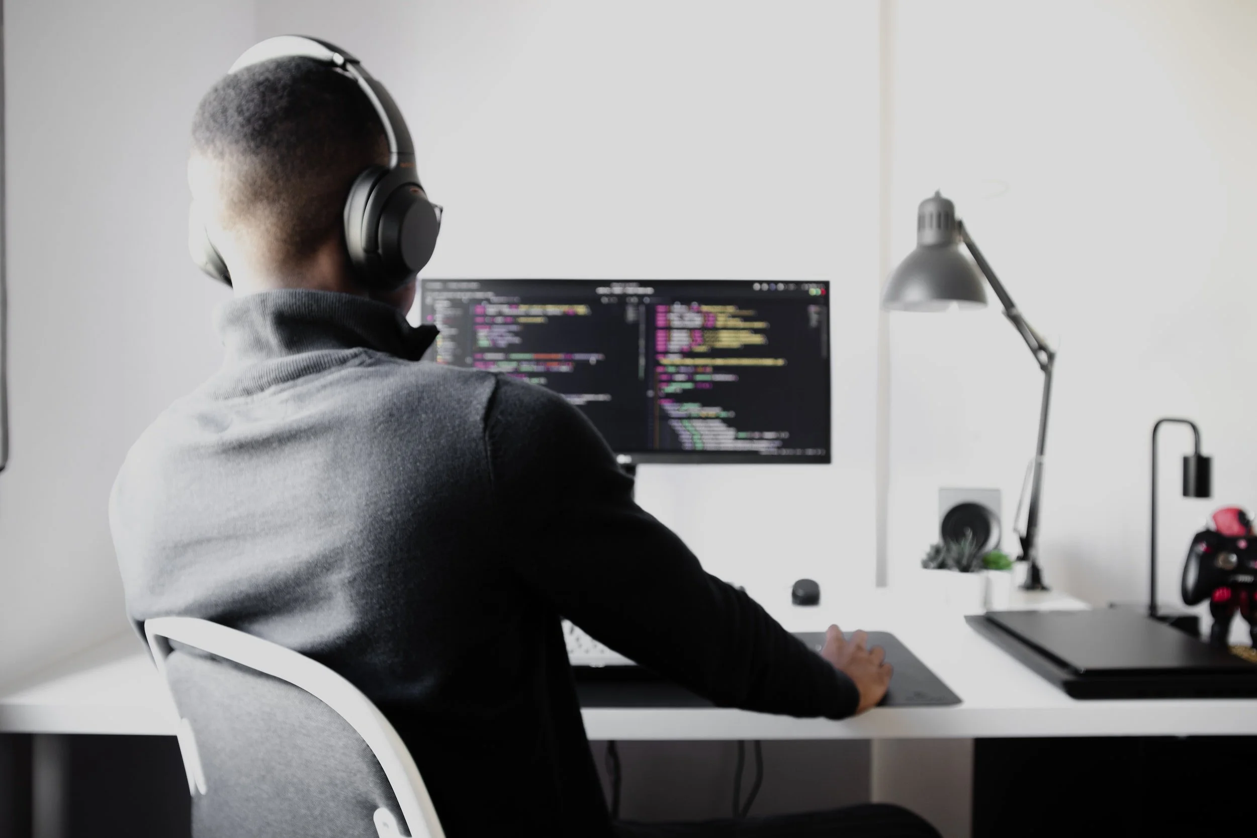 Developer coding at multiple monitors
